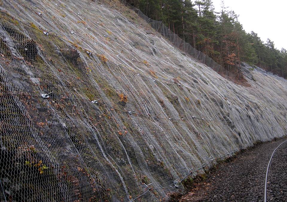 Slope stabilization systems (steel grid netting, guniting)
